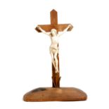 λ A 19th century carved ivory Corpus Christi, mounted on a walnut cross, the figure: 24.5cm high.