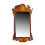 A George II walnut fret-frame wall mirror, the later bevelled plate within a moulded frame and