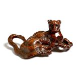 A Japanese rootwood carving of a recumbent cat, late 19th / early 20th century, 33cm long.