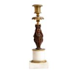 An early 19th century gilt and patinated bronze figural candlestick, the stem with three classical