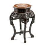 A late 19th century Chinese hardwood jardinière stand, the octagonal top inset with marble, the