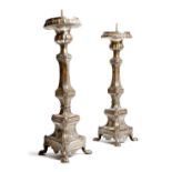 A pair of Italian silvered brass altar candlesticks, of triform shape, the stems decorated with
