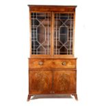 A mahogany secretaire cabinet, with a pair of geometric astragal glazed doors enclosing ten