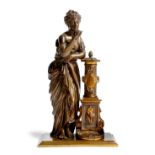 A 19th century French gilt and patinated bronze model of a classical maiden, drinking water from a