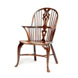 A George III fruitwood and yew Windsor armchair, with a pierced splat back above an elm seat, on