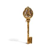 A rare 18th century Bohemian gilt steel chamberlain's key, the pierced bow surmounted with an