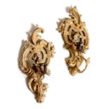 A pair of George III giltwood girandoles, each decorated with leaf scrolls, with a mirrored back and