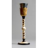 λ A turned ivory and ebony chalice, with a white metal bowl with a fret carved slip