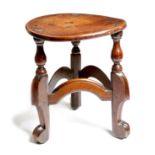 An unusual oak stool, the circular top on turned tripod 'horsebone' type legs, united by moulded