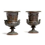 A pair of 19th century French Grand Tour bronze Medici type urns, relief decorated with cherubs,