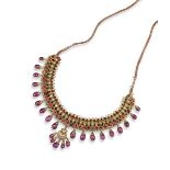 An Indian gem-set gold fringe necklace, mounted with seed pearls, small diamonds, pear-shaped red-