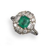 An Art Deco emerald and diamond cluster ring, the emerald-cut emerald set with two baguette-shaped