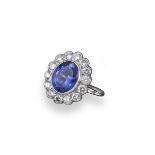 A tanzanite and diamond cluster ring, the oval-shaped tanzanite weighs approximately 1.35cts and