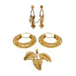 A pair of gold filigree hoop earrings, and a naturalistically formed gold leaf brooch, and a pair of