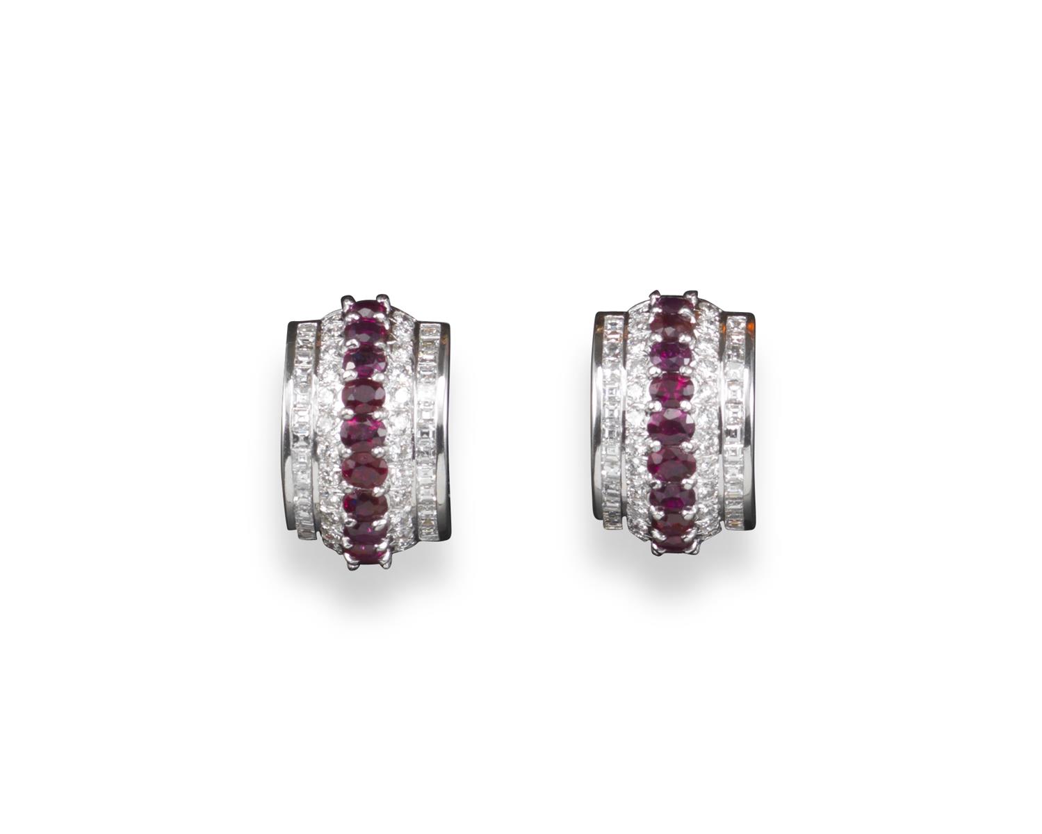 A pair of ruby and diamond crescent-shaped earrings, set with a centre line of oval-shaped rubies