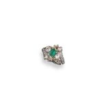 An emerald and diamond cluster ring, the baguette-shaped emerald set with graduated circular-cut