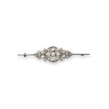 An early 20th-century diamond-set bar brooch, centred with a quatrefoil of circular-cut diamonds,