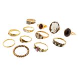 Twelve assorted gold rings, including: a 19th-century mourning ring, a pearl and emerald half hoop