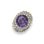 An amethyst and diamond-set cluster ring, the circular cut amethyst is pavé-set within a surround of