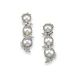 A pair of triple graduated South Sea cultured pearl and diamond drop earrings, the pearls graduate