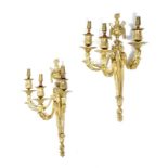 A pair of late 19th century French ormolu wall lights in Louis XVI style, with a flaming urn and