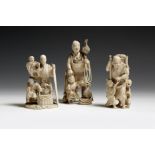 λ Three Japanese carved ivory okimono, one of a samurai with two boys, the others of fishermen with