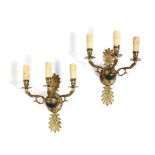 A pair of gilt and patinated brass three-light wall appliques in Empire style, early 20th century,