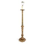 An Italian painted and carved giltwood standard lamp, the spiral fluted stem decorated with leaves