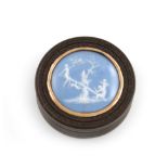 λA late-18th / early-19th century composition snuff box, circular form, the pull-off cover inlaid