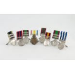 A collection of eight menu card holders formed from medals, two by Horton & Allday, Birmingham 1902,
