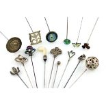 A collection of fifteen various silver hat pins, comprising: an Edwardian one modelled as a standing