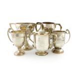 A collection of five silver regimental trophy cups, comprising: an Indian one by Hamilton and Co, '