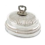 A 19th century old Sheffield plated meat dish cover, oval form, fluted decoration, central foliate