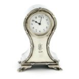 A silver clock, by Charles and Richard Comyns, London 1916, bombé form, ribbon and reed border,