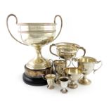 A collection of seven silver regimental trophy cups, comprising: 'The Henry R. Webb Challenge