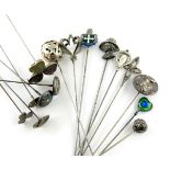 A collection of fifteen silver hat pins, comprising: an Edwardian one by Charles Horner, Chester