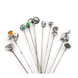 A collection of ten Charles Horner silver hat pins, comprising: one of thistle form, with wire-