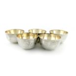 A matched set of five regimental silver finger bowls, by D and J Wellby, London 1907, and Wakely and