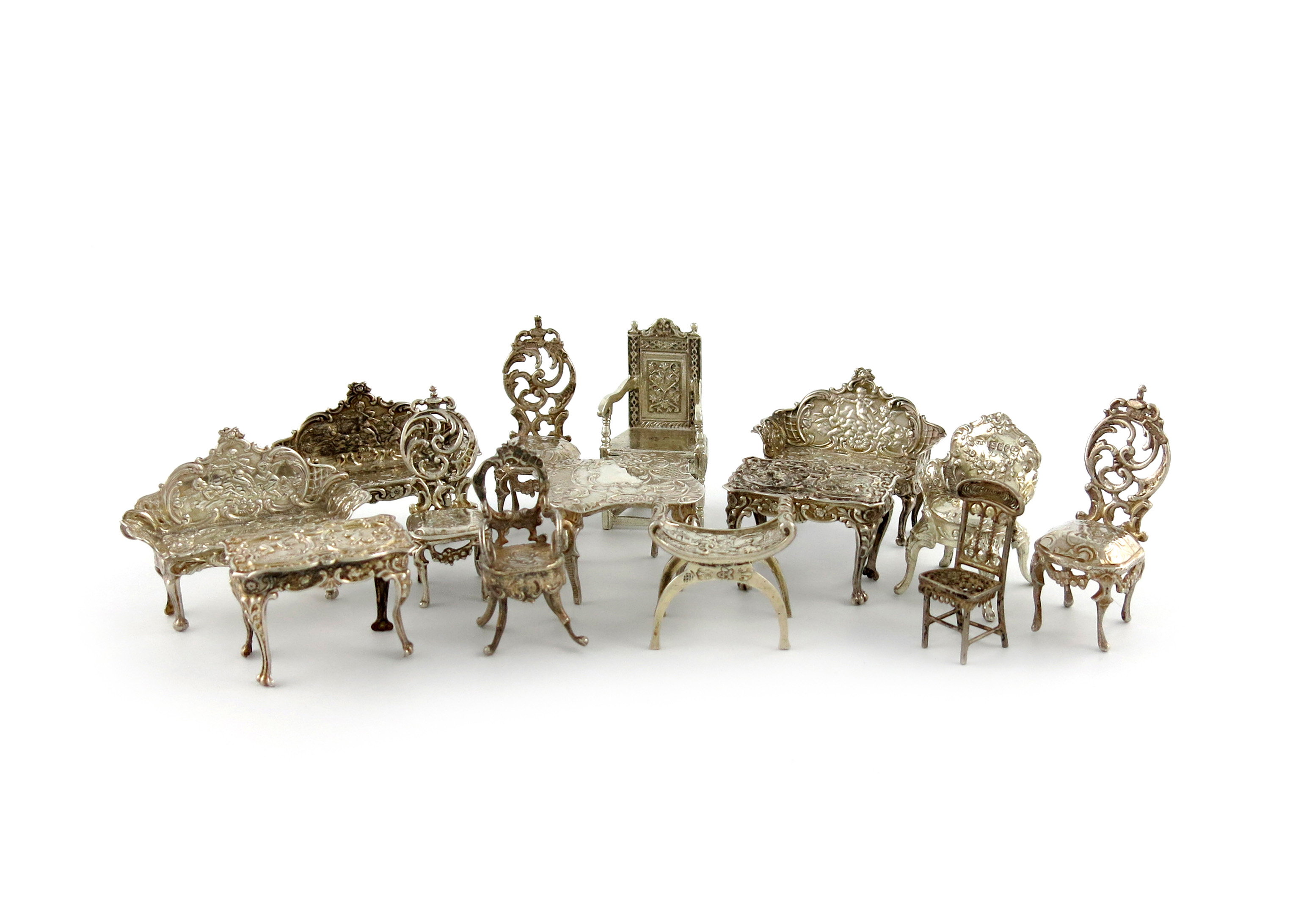 A collection of fourteen miniature silver tables and chairs, various dates and makers, comprising: