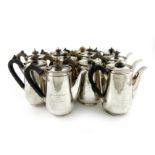 A matched set of eleven presentation silver coffee pots, by D and J Wellby, London 1908/09, and