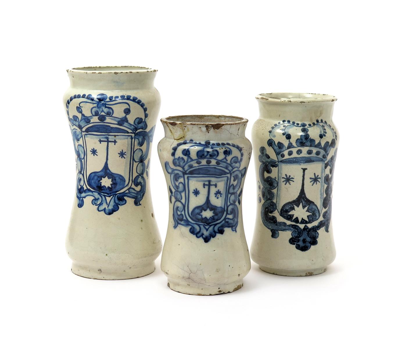 Three Talavera albarelli, c.1760, the waisted forms each painted in blue with a variation of a