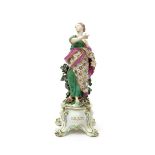 A Chelsea Gold Anchor figure of one of the Nine Muses, c.1760-65, probably Thalia, holding a