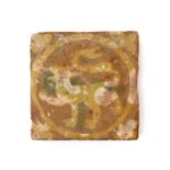 A medieval encaustic tile, 13th century, decorated in cream slip on a terracotta ground with a