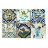 Six Delft tiles, early 17th century, two painted with a vase of flowers with dark blue motifs to the