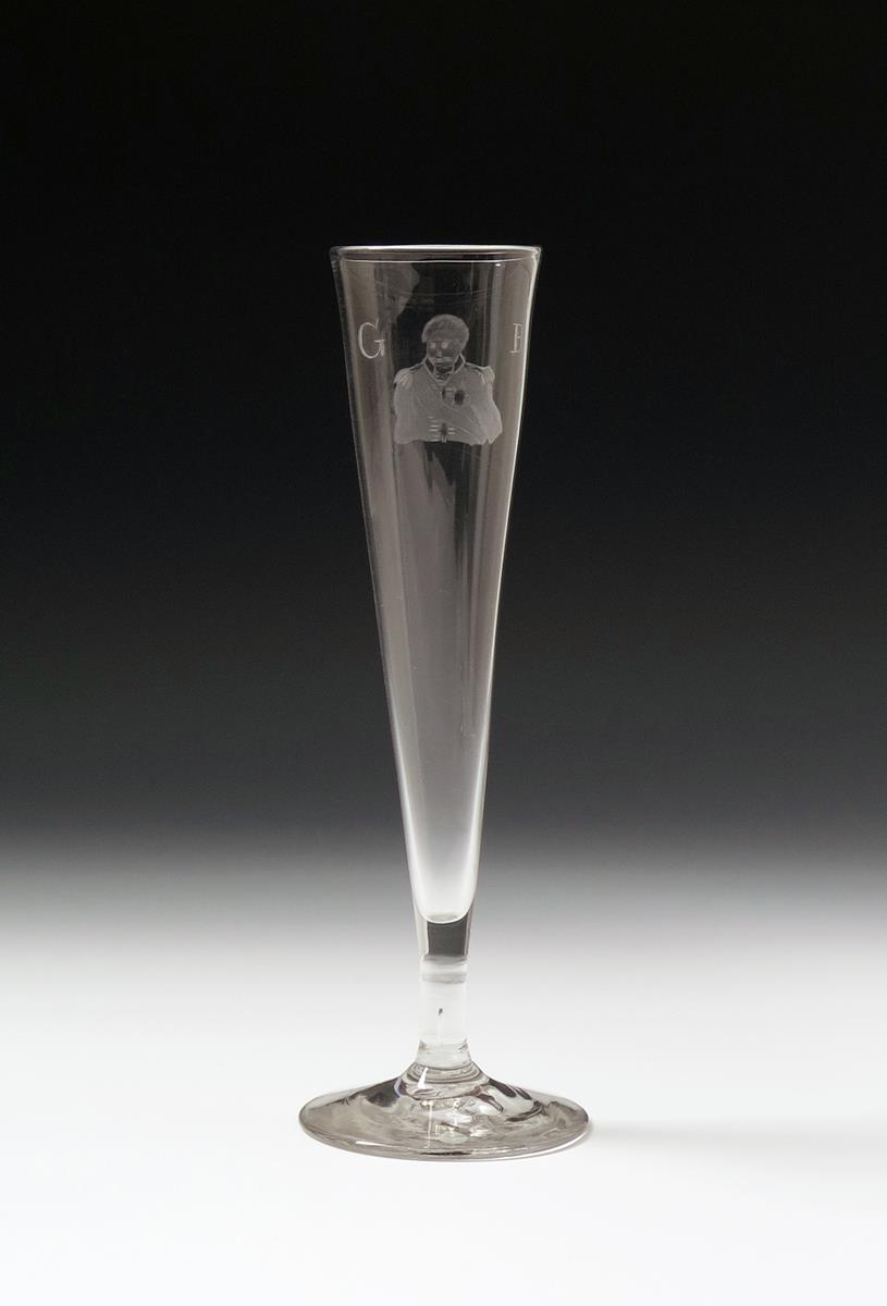 A tall glass flute, 1st half 19th century, the slender drawn bowl engraved with a portrait of the