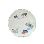 A Chantilly lobed saucer, c.1730-35, painted in the Kakiemon palette with a version of the Two Quail
