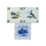 Three delftware tiles, c.1760, two painted in polychrome enamels with long-tailed birds strutting