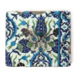 A Damascus pottery tile, c1570-90, painted in the Iznik manner with stylized flowers and seedheads