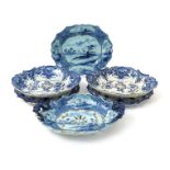 Three Delft strawberry dishes and stands, 18th century, two painted with peony sprays within