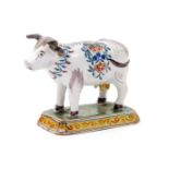 A Delft model of a cow, possibly 18th century, after Adrianus Kocks, standing four square on a